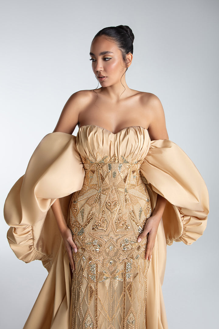 Strapless Gown With Draped Bodice And Sculptural Cape