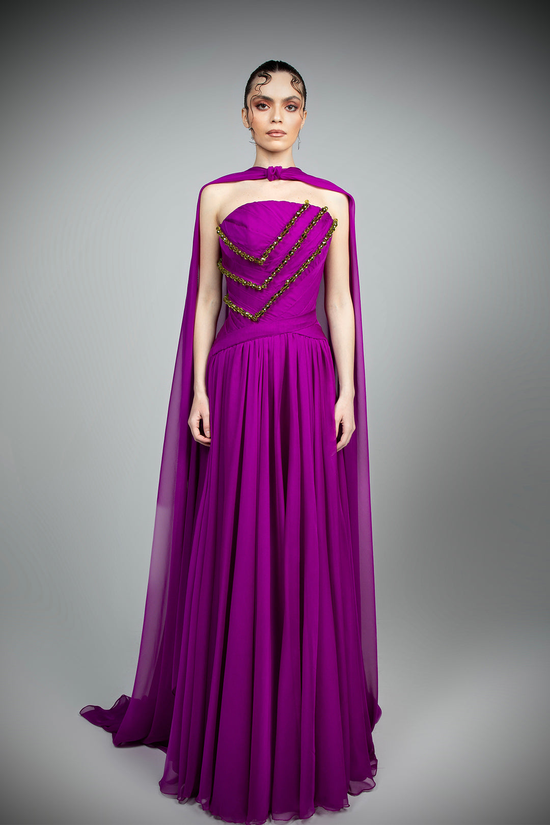 silk mousseline dress A silk mousseline dress with metallic leaf embroidery stitched in silk threads, with a sandstone tint. Translating intricate craftsmanship, the corset top flows into a flared skirt that is accentuated